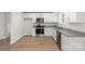 Bright kitchen boasts granite countertops, stainless steel appliances, and light wood flooring at 419 N Caldwell St # 1, Salisbury, NC 28144