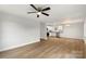 Open-concept living space with a kitchen featuring white cabinets, stainless steel appliances, and laminate flooring at 419 N Caldwell St # 1, Salisbury, NC 28144
