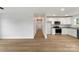 Open-concept living area featuring wood floors and modern white cabinets in the kitchen at 419 N Caldwell St # 1, Salisbury, NC 28144
