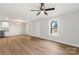 Inviting living room featuring modern ceiling fan, wood floors, and an entry door and large bright window at 419 N Caldwell St # 1, Salisbury, NC 28144