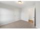 Bedroom features neutral carpet, light walls, white doors, and an open doorway at 423 N Caldwell St # 2, Salisbury, NC 28144
