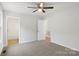 Bedroom features neutral carpeting, white walls, ceiling fan, and two bright entrances at 423 N Caldwell St # 2, Salisbury, NC 28144