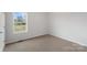 Bedroom with neutral carpet, a bright window, and light-colored walls at 423 N Caldwell St # 2, Salisbury, NC 28144