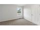 Bedroom featuring neutral carpet, light walls, a bright window, and a white door at 423 N Caldwell St # 2, Salisbury, NC 28144