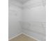 Walk-in closet with white wire shelving, neutral carpeting, and ample storage space at 423 N Caldwell St # 2, Salisbury, NC 28144