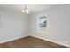 Dining room features a modern light fixture, light-wood floors, white walls and a bright window view at 423 N Caldwell St # 2, Salisbury, NC 28144