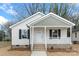 Close-up of an inviting single-Gathering home with a classic front porch and well-maintained landscaping at 423 N Caldwell St # 2, Salisbury, NC 28144