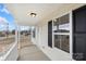 Inviting front porch featuring classic columns, crisp white railings, and ample natural light at 423 N Caldwell St # 2, Salisbury, NC 28144