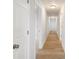 Hallway features light-wood flooring, white walls, white doors, and flush mount lighting at 423 N Caldwell St # 2, Salisbury, NC 28144