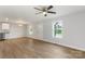 Open-concept living space featuring wood-look floors, ample natural light, and a view of the kitchen at 423 N Caldwell St # 2, Salisbury, NC 28144