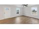 Bright and airy living room with wood-look floors, crisp white walls, and multiple windows at 423 N Caldwell St # 2, Salisbury, NC 28144