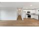 Open-concept living area with hardwood floors, white walls, and a seamless flow to the kitchen at 423 N Caldwell St # 2, Salisbury, NC 28144