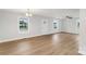 Bright living room with light-wood floors, white walls, large windows, and a clear front door at 423 N Caldwell St # 2, Salisbury, NC 28144