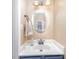 Features a vanity with a white countertop, an elegant mirror, and decorative lighting at 4405 Ashton Ct, Indian Trail, NC 28079
