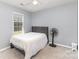 This bedroom has neutral gray paint, a ceiling fan, and a single window at 4405 Ashton Ct, Indian Trail, NC 28079