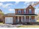 Charming two-story brick home with a well-maintained front yard and covered porch at 4405 Ashton Ct, Indian Trail, NC 28079