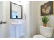 Well-lit powder room featuring pedestal sink, framed mirror and decor at 50 Sherwood Nw Ct # Sw50, Concord, NC 28027