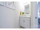 Clean powder room with white vanity, framed mirror, and modern fixtures at 50 Sherwood Nw Ct # Sw50, Concord, NC 28027
