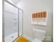 Bathroom featuring a walk-in shower with glass doors, toilet, and decorative towel display at 50 Sherwood Nw Ct # Sw50, Concord, NC 28027