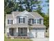 Beautiful two-story home with stone accents, a covered porch, and a two-car garage at 50 Sherwood Nw Ct # Sw50, Concord, NC 28027