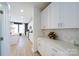 Modern kitchen with white cabinets, sleek countertops, and stainless steel appliances at 50 Sherwood Nw Ct # Sw50, Concord, NC 28027