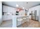 Modern kitchen featuring white cabinets, stainless steel appliances, a center island, and stylish pendant lighting at 50 Sherwood Nw Ct # Sw50, Concord, NC 28027