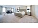 Expansive main bedroom featuring sitting area, plush bed, and neutral decor creating a luxurious retreat at 50 Sherwood Nw Ct # Sw50, Concord, NC 28027