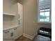 Bright laundry room with modern appliances, white cabinetry, and a window offering natural light at 5104 Lowie Ln # 23, Gastonia, NC 28056