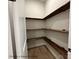 Walk-in pantry with ample wooden shelving for organized storage of food and kitchen essentials at 5104 Lowie Ln # 23, Gastonia, NC 28056