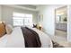 Bedroom featuring a large window and an open doorway leading to a bathroom at 527 Morrows Turnout Way, Pineville, NC 28134