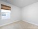 Minimal bedroom with a large window and neutral carpet flooring at 527 Morrows Turnout Way, Pineville, NC 28134