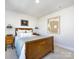 Classic bedroom with a cozy bed, warm lighting, and vintage artwork at 527 Morrows Turnout Way, Pineville, NC 28134