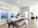 A bright dining room with lots of natural light, a table with chairs and a bench, adjacent to the backyard at 527 Morrows Turnout Way, Pineville, NC 28134