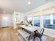 Bright dining room boasts natural light, modern decor, and a table with a bench on an area rug at 527 Morrows Turnout Way, Pineville, NC 28134