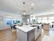 This spacious island has a marble countertop, modern lighting, and a stainless steel dishwasher, which opens into a dining area at 527 Morrows Turnout Way, Pineville, NC 28134