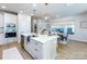 The spacious kitchen features a large island with marble countertops and modern pendant lighting above the table at 527 Morrows Turnout Way, Pineville, NC 28134