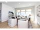 This bright living room has recessed lighting, a couch with throw pillows, chairs, and a wooden coffee table at 527 Morrows Turnout Way, Pineville, NC 28134