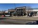 Street view of commercial buildings with dark brick facades featuring local dining and retail at 527 Morrows Turnout Way, Pineville, NC 28134