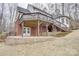 Backyard view featuring a patio, stairs leading to a wooden deck, and mature trees at 5306 Club View Dr, Concord, NC 28025