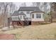 Rear view of the house showing a backyard, wooden deck, stairs, and outdoor living space at 5306 Club View Dr, Concord, NC 28025