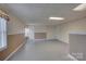 Finished basement with neutral paint, tile ceiling, ample space, and a cozy atmosphere at 5306 Club View Dr, Concord, NC 28025