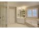 Luxurious bathroom featuring a soaking tub, walk-in shower, and white vanity at 5306 Club View Dr, Concord, NC 28025