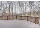 View of wooded backyard from a brown wooden deck with railings, ready for outdoor relaxation and entertainment at 5306 Club View Dr, Concord, NC 28025