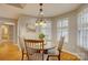 Cozy dining area with hardwood floors, decorative lighting, and natural light from shuttered windows at 5306 Club View Dr, Concord, NC 28025