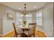 Cozy dining nook featuring chandelier and natural light from large windows with white shutters at 5306 Club View Dr, Concord, NC 28025