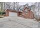 Traditional brick home with a large driveway and attached two-car garage at 5306 Club View Dr, Concord, NC 28025