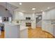 Bright kitchen featuring white cabinetry, stainless steel appliances, and hardwood floors at 5306 Club View Dr, Concord, NC 28025