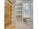 Functional storage area featuring shelving, wood paneled wall, and a window for natural light at 5306 Club View Dr, Concord, NC 28025
