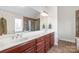 Elegant bathroom with double vanity, tile flooring, and a large mirror reflecting the shower at 5608 Old Town Ln, Gastonia, NC 28056