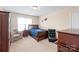 Cozy bedroom features carpet, a double window, and comfortable seating including a armchair and a gaming chair at 5608 Old Town Ln, Gastonia, NC 28056